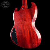 Red electric guitar body with a visible brand logo in the corner.