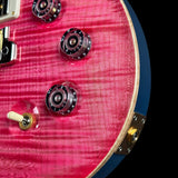 Close-up of a red electric guitar's control knobs and switch on a black background