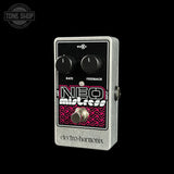 Electro-Harmonix Neo Midtone guitar effects pedal with a silver metal casing, black faceplate, black knobs, and a pink and white graphic design on a solid black background.