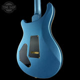 Blue electric guitar body with a visible brand logo in the corner.
