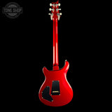 Red electric guitar on a black background with 'Tone Shop' logo.