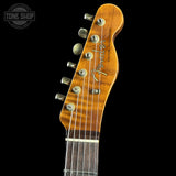 Guitar headstock with Fender logo on a black background