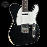 Black electric guitar with white pickguard on a black background, featuring 'Tone Shop' branding.