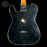 Back of a black electric guitar with visible wear, brand logo at the top.