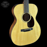 Acoustic guitar with a visible brand logo in the corner