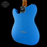 The back of a blue electric guitar with a maple body, a black Tune Shop plate, and a brown wood neck, shown against a black background.