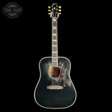 Acoustic guitar with a black finish on a white background