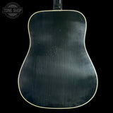 Back view of a black acoustic guitar with 'Tone Shop' logo.