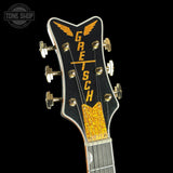 Gretsch guitar headstock with gold and black design on a black background