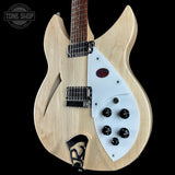 Electric guitar with a split design, half natural wood and half white, on a black background. Brand 'Tone Shop' visible.