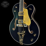 Electric guitar with gold hardware on a black background, featuring the Tone Shop logo.