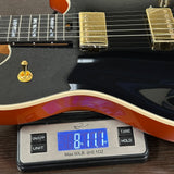 EVH Custom Shop Wolfgang 2H Black Metallic/Candy Tangerine on a scale displaying weight.
