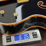 Guitar on a digital scale displaying weight
