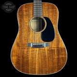 Acoustic guitar with a visible brand logo in the corner