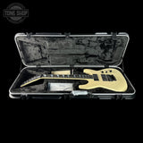 Electric guitar in an open hard-shell case with 'Tone Shop' logo.