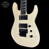 White electric guitar with a 'Tone Shop' logo in the corner