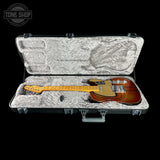 Guitar in a hard-shell case with 'Tone Shop' logo.