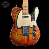 Fender electric guitar with a sunburst finish on a black background, featuring the Tone Shop logo.