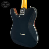 Glossy black electric guitar body with visible brand logo on a black background
