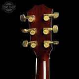 Close-up of a guitar headstock with Tuner Master tuners on a black background, featuring the Tone Shop logo.