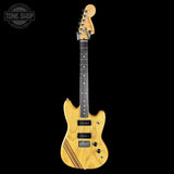 Electric guitar with a natural wood finish on a black background, featuring the Tone Shop logo.