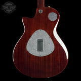 Close-up of a guitar body with a visible brand logo in the corner.