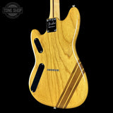 Wooden electric guitar body with brand logo on a black background