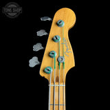 Fender bass guitar headstock with tuning pegs on a black background