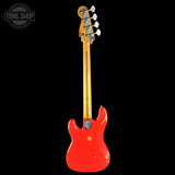 Red electric guitar with a black background, featuring the Tone Shop logo.