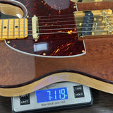 Electric guitar on a digital scale displaying weight
