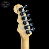 Guitar headstock with tuning pegs on a black background, featuring 'Tone Shop' branding.