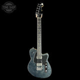 Blue electric guitar on a black background with 'Tone Shop' logo.