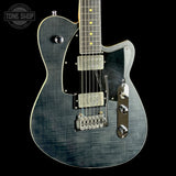 Electric guitar with a black and silver finish on a black background, featuring the Tone Shop logo.