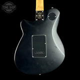 Black electric guitar with a visible brand logo on a black background