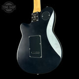 Black electric guitar with a visible brand logo on a black background