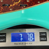 Fender Custom Shop 1962 Jazzmaster Journeyman Relic PHC Sea Foam Green on a scale displaying weight.