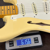 Used 2018 Fender Eric Johnson Thinline Strat Vintage White on scale displaying weight.