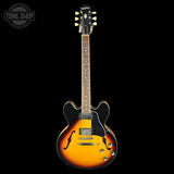 Electric guitar with a sunburst finish on a black background, featuring the Epiphone logo.