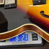 Electric guitar on a digital scale displaying weight