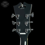 Guitar headstock with tuning pegs on a black background, featuring 'Tone Shop' branding.
