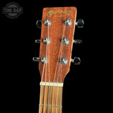 Close-up of a guitar headstock with 'Martin & Co' branding on a black background.