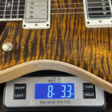 Guitar on a digital scale displaying weight