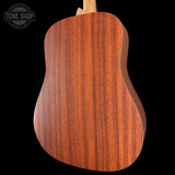 Close-up of a wooden acoustic guitar back with 'Tone Shop' logo.