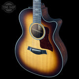 Acoustic guitar with a sunburst finish on a black background, featuring the Tone Shop logo.
