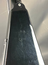 Scratched black surface on a metallic background