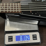 Guitar on a digital scale displaying weight