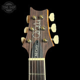 Guitar headstock with brand name on a black background