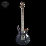 Electric guitar with a black glitter finish on a white background, featuring the Tone Shop logo.