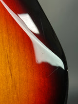 Close-up of a car spoiler on a wooden surface with a gradient background