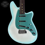 A double-cutaway electric guitar with a light blue to white gradient body, a teal pickguard, and a dark fretboard, shown against a solid black background. A Tone Shop watermark is visible in the top-left corner.